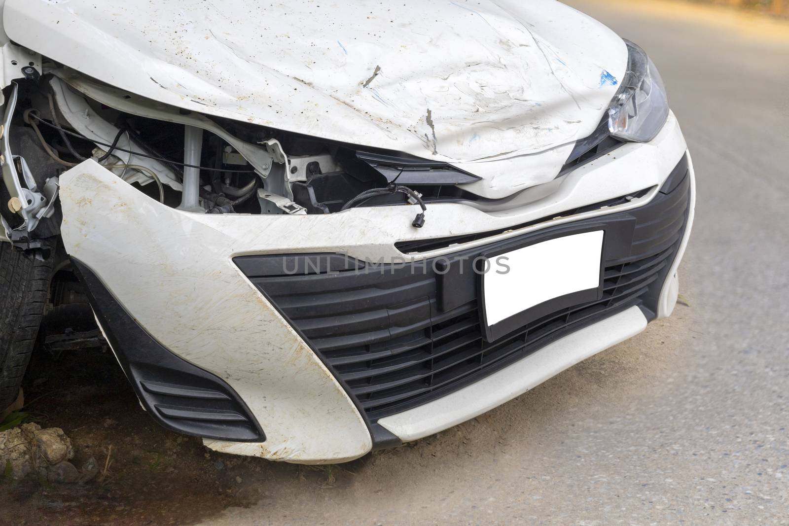Front of white color car big damaged and broken by accident on road parking can not drive any more. With copy space for text or design