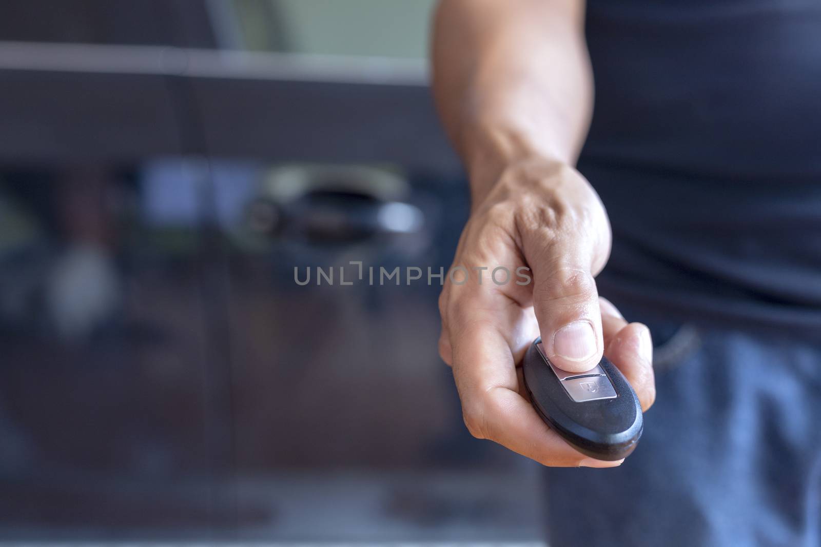Hand man hode car remote for open the car. Soft focus and focus selective remote.