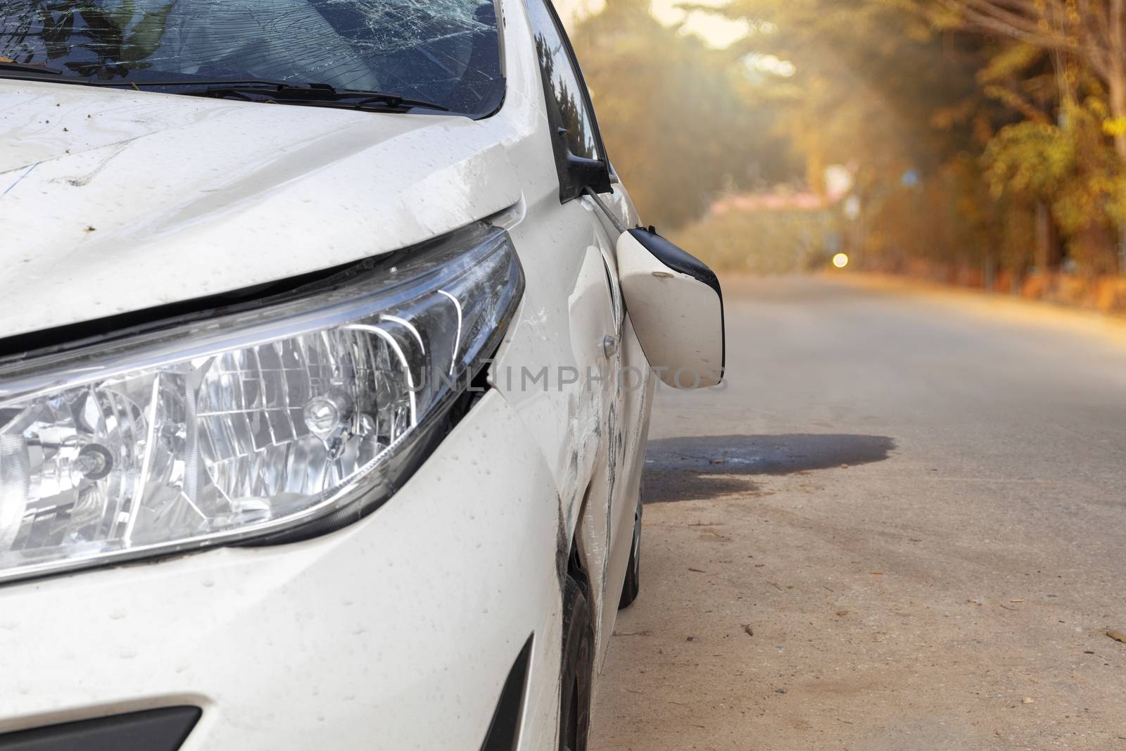 Car accident on road car door and rearview mirror  broken. Front of white color car damaged and broken by accident on road. Save with clipping path.