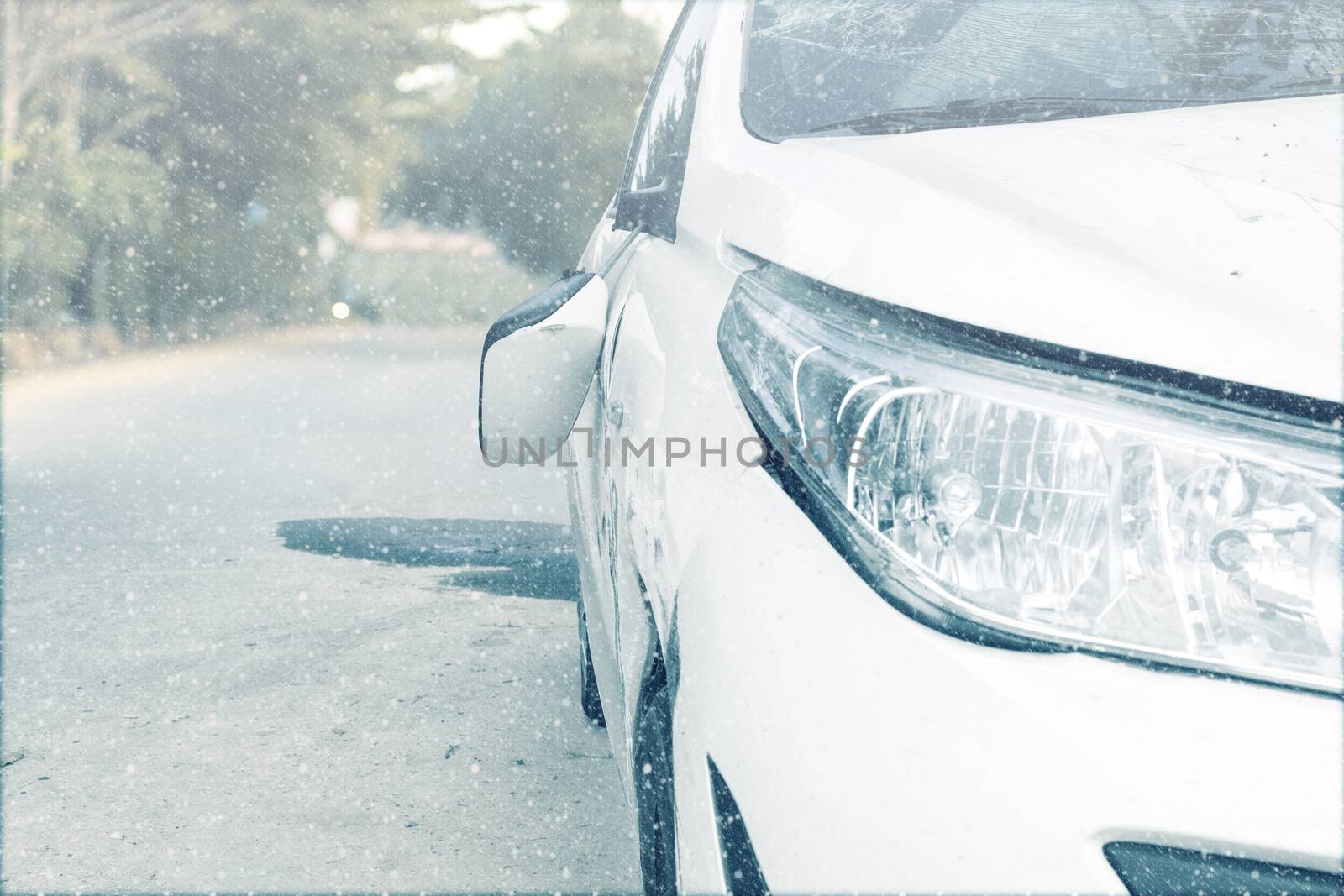 Car accident on winter road car door and rearview mirror  broken. Front of white color car damaged and broken by accident on winter road. Save with clipping path.