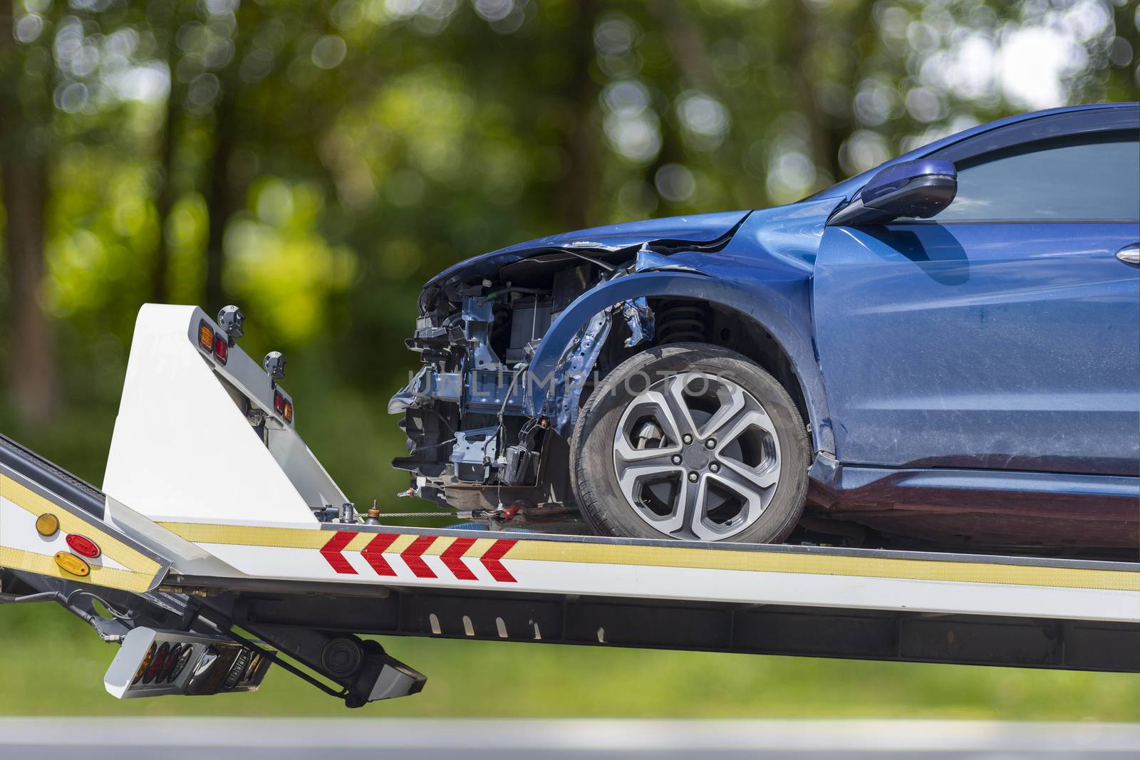 accident Car Slide on truck for move. Blue car have damage by accident on road take with slide truck move . 