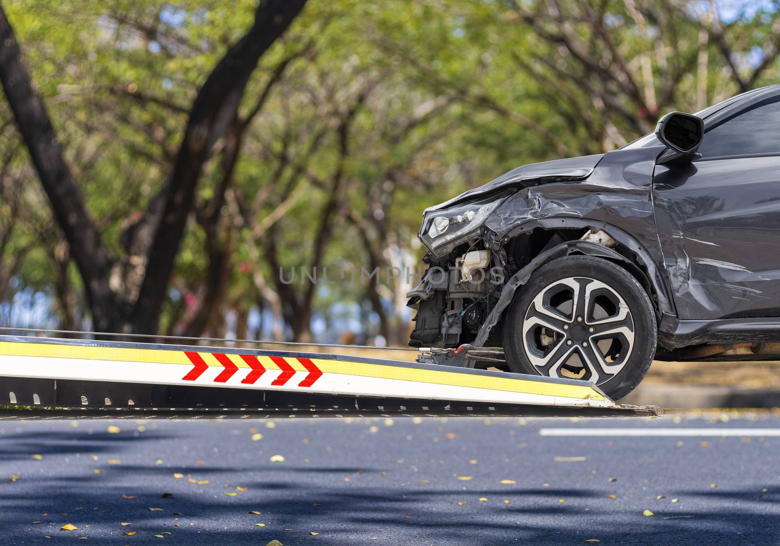 accident Car Slide on  truck for move. Balck car have damage by accident on road take with slide truck move . Isolate on white background.