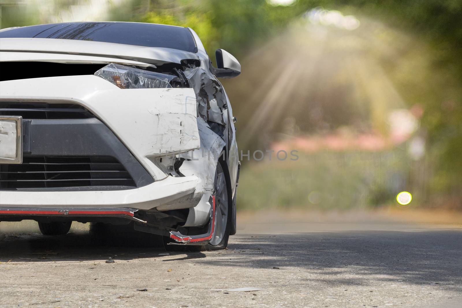 Front of white color car big damaged and broken by accident on city street parking can not drive any more. With copy space for text or design