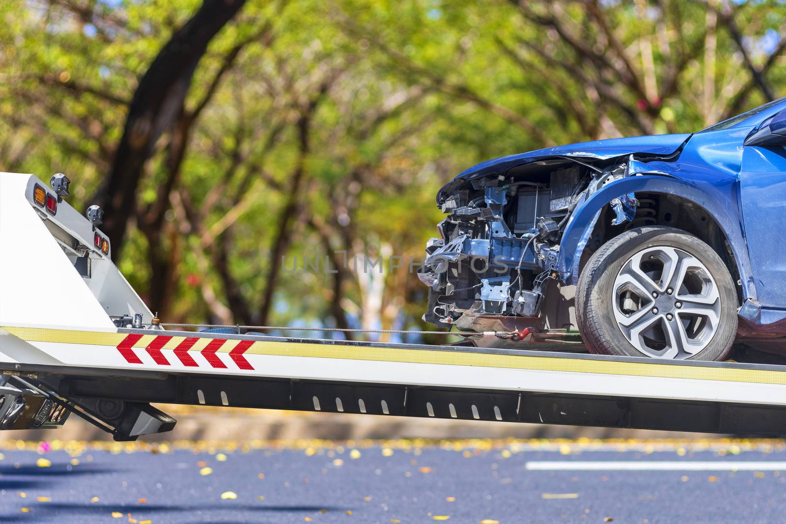 accident Car Slide on truck for move. Blue car have damage by accident on road take with slide truck move . 