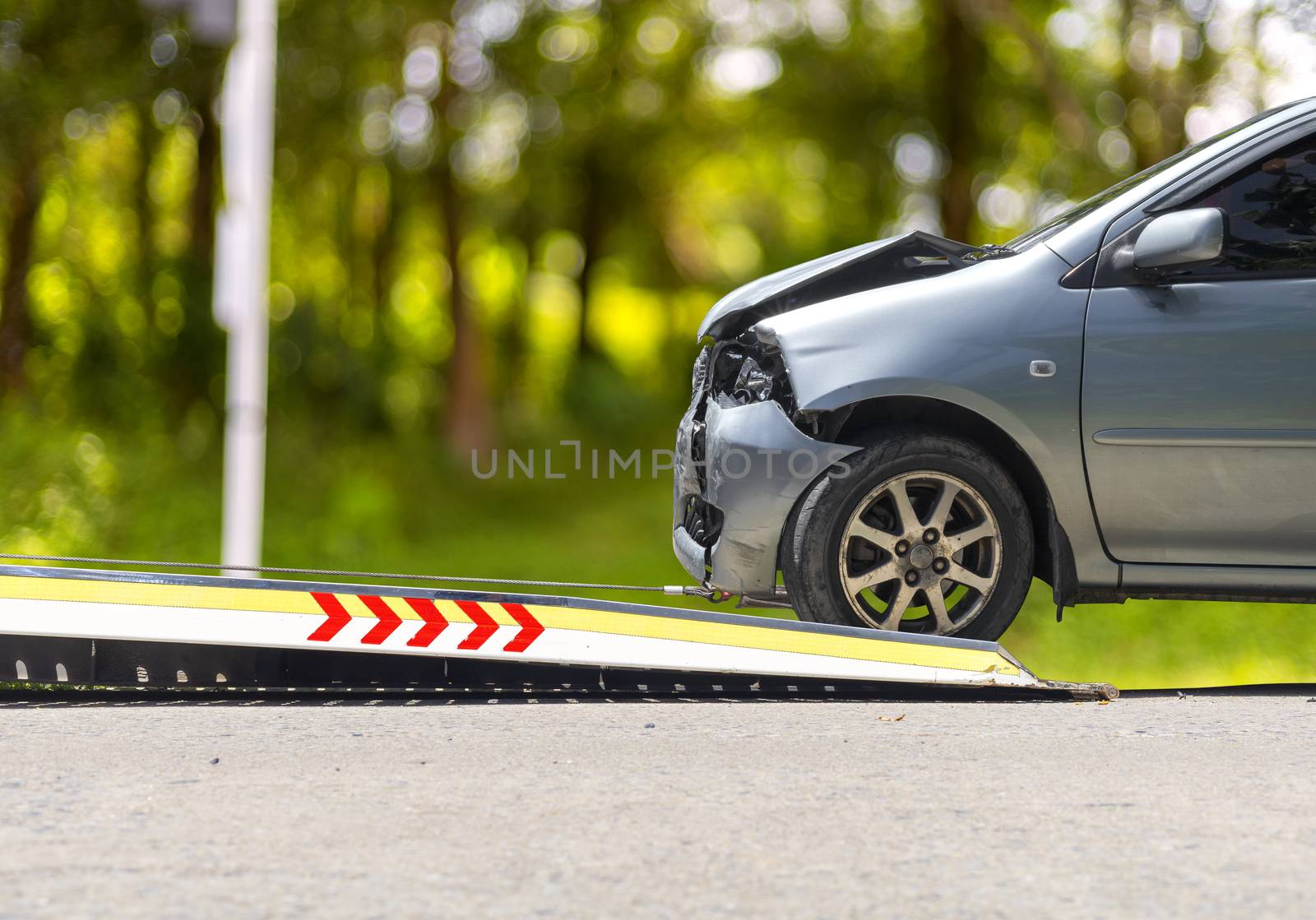 accident Car Slide on  truck for move. Gray car have damage by accident on road take with slide truck move . 