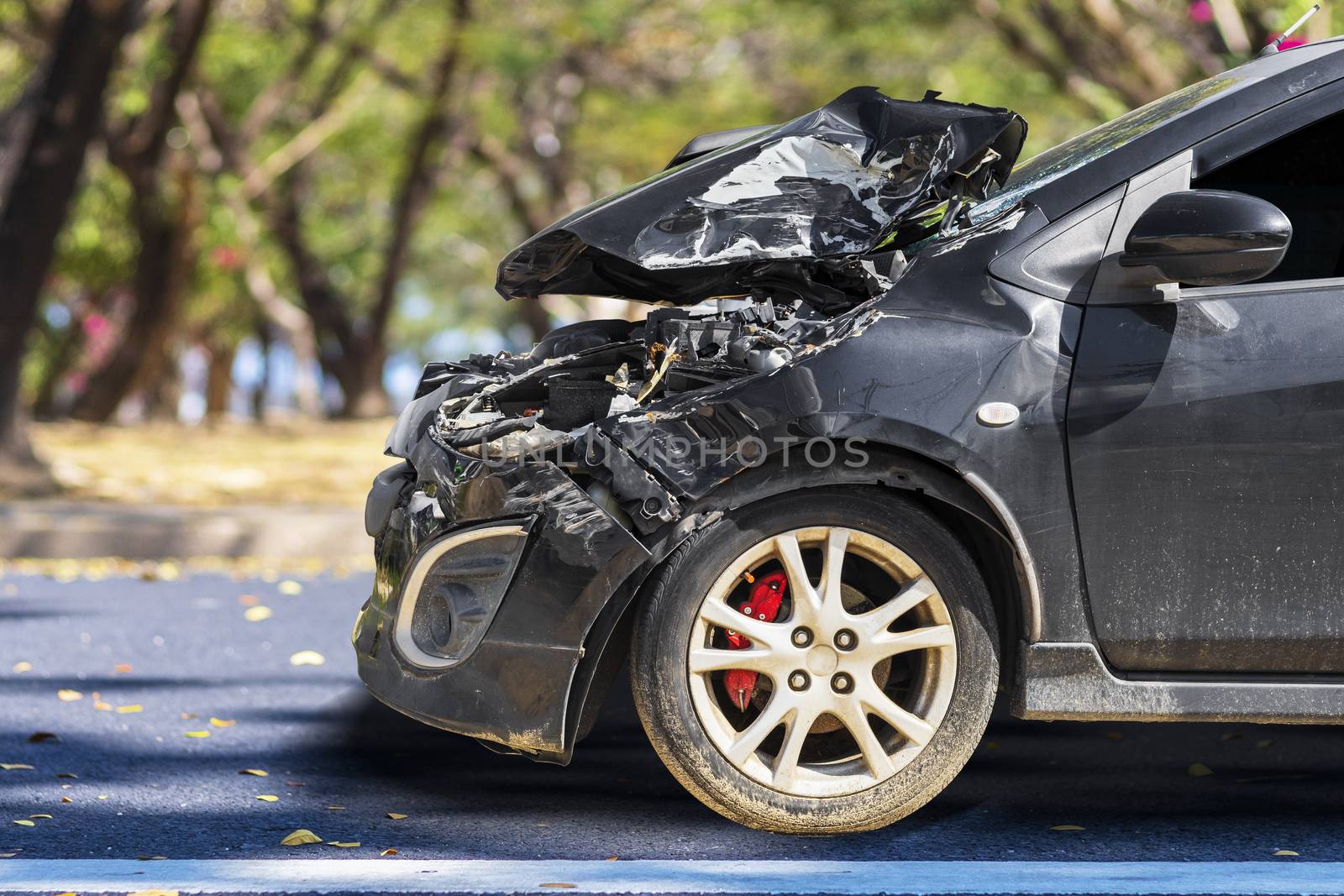 Front of black color car big damaged and broken by accident on city street parking can not drive any more. With copy space for text or design