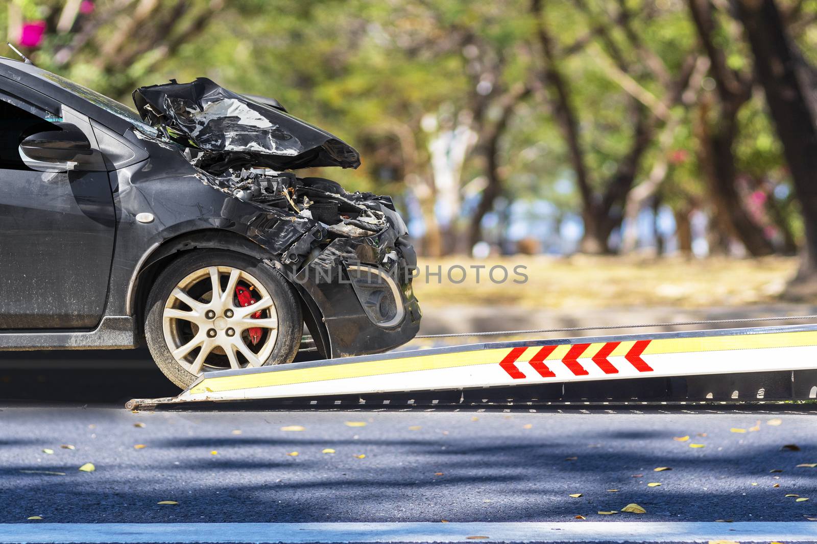 accident Car Slide on truck for move. Black car have damage by accident on road take with slide truck move . 