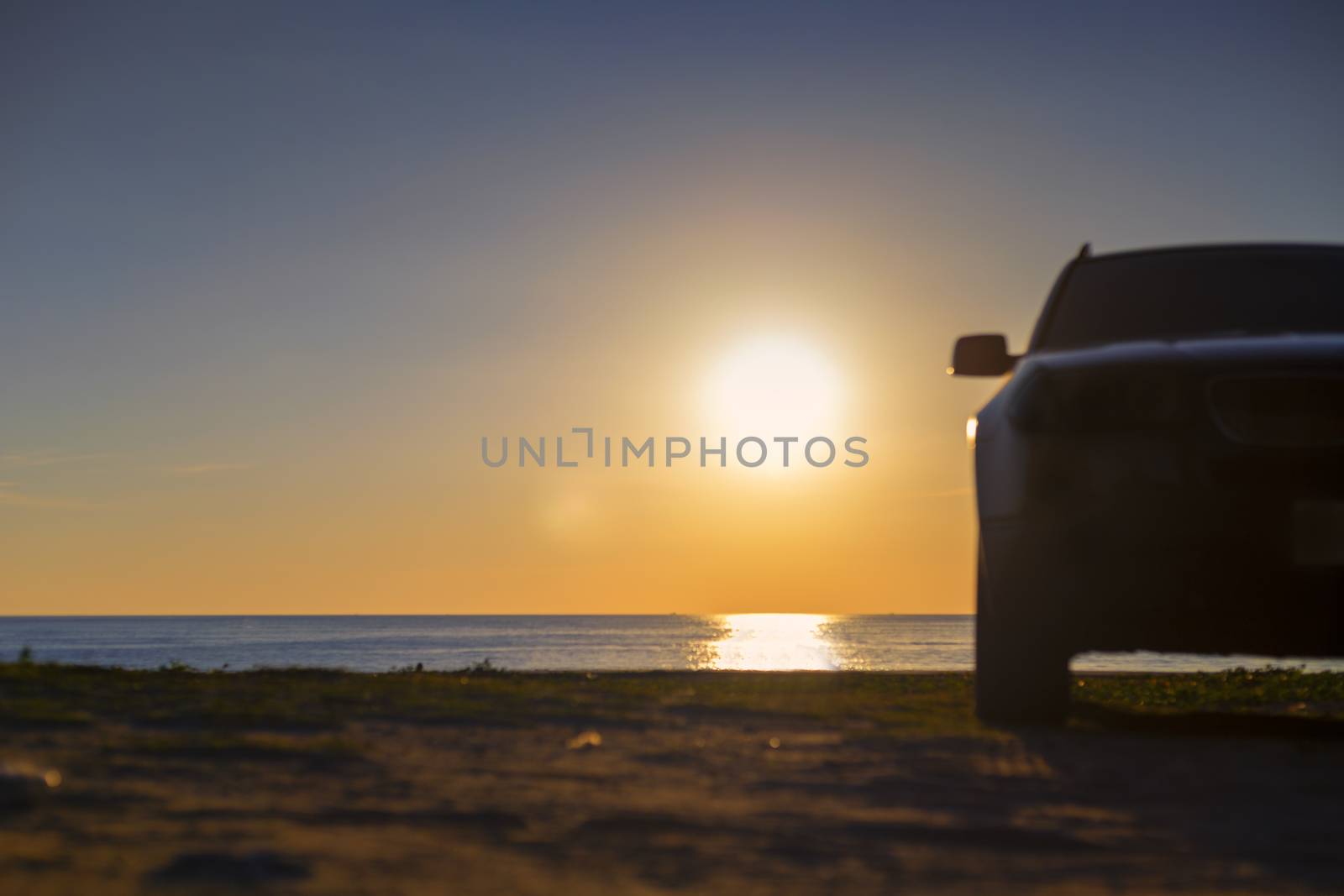 Summer concept silhouette car park on sand with  sunset clear sky and beach background. With copy space for text or design.