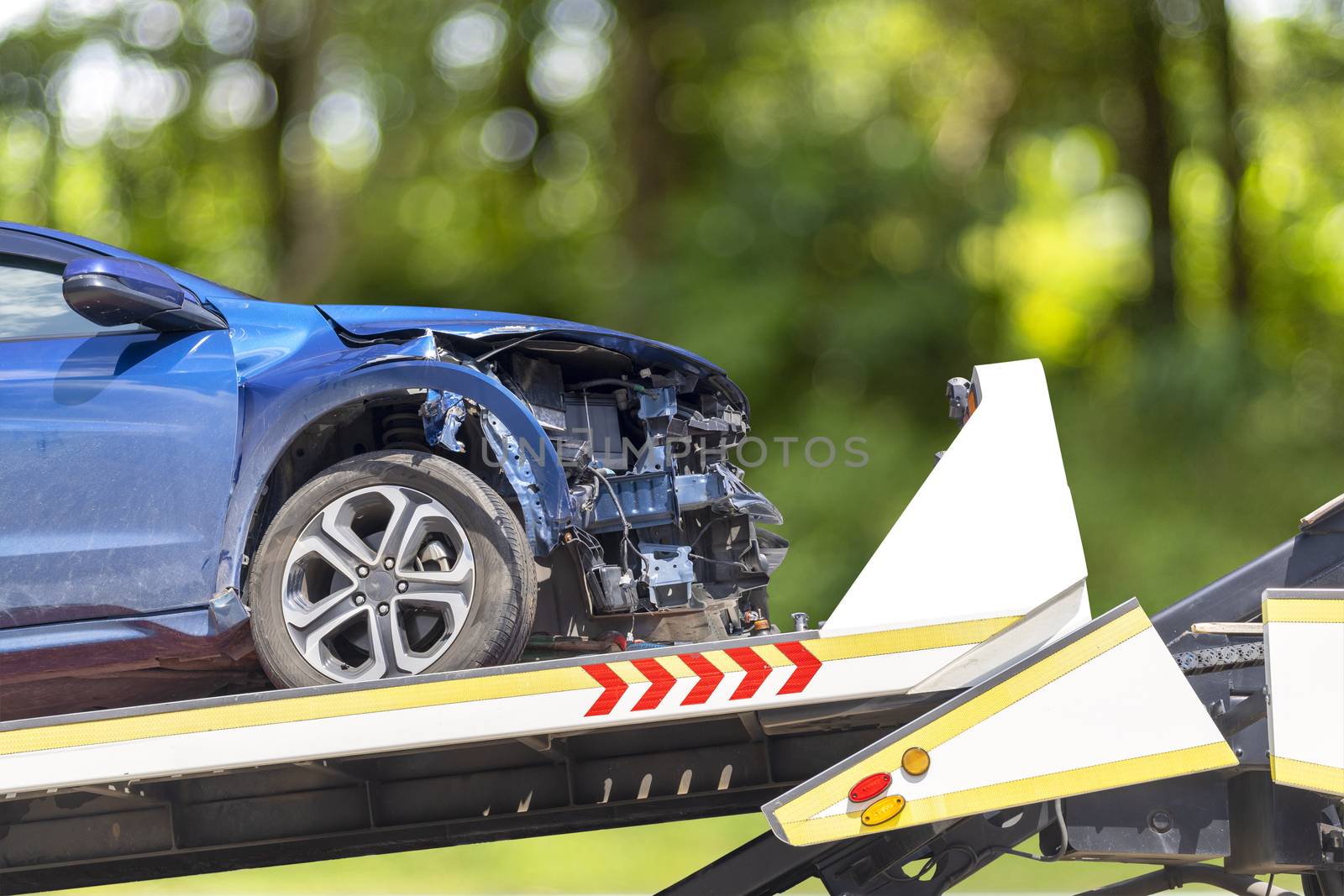 accident Car Slide on truck for move. Blue car have damage by accident on road take with slide truck move . Isolate on white background .