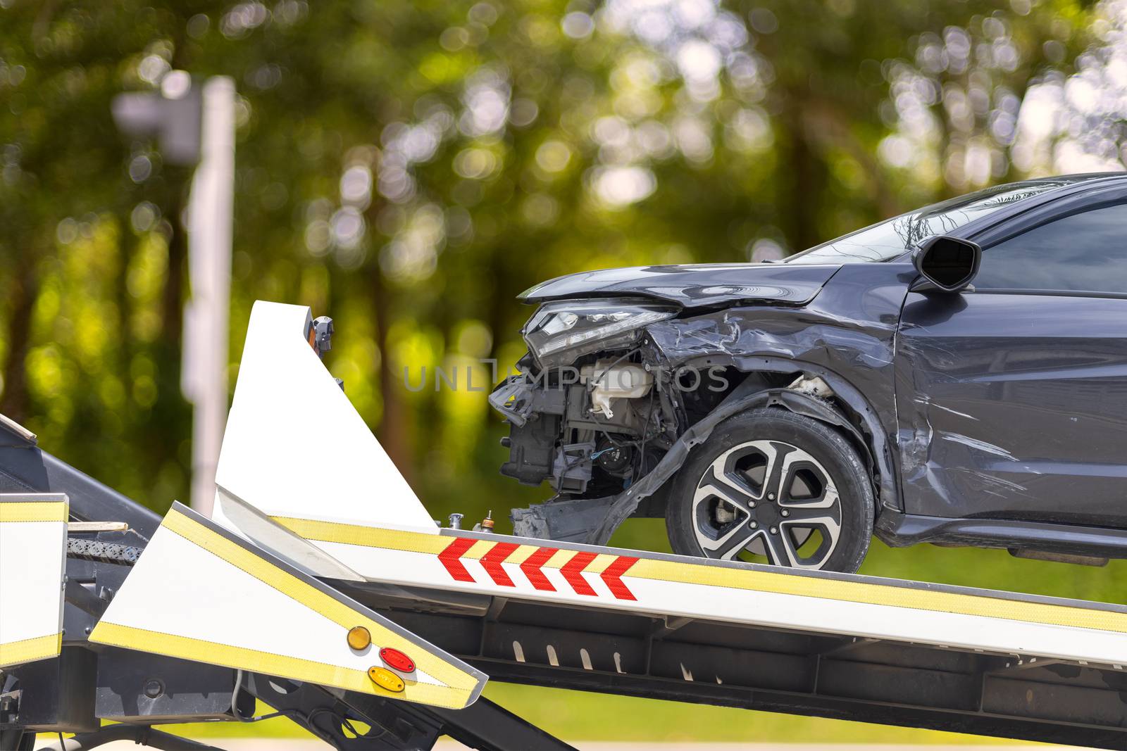 accident Car Slide on truck for move. Black car have damage by accident on road take with slide truck move . 