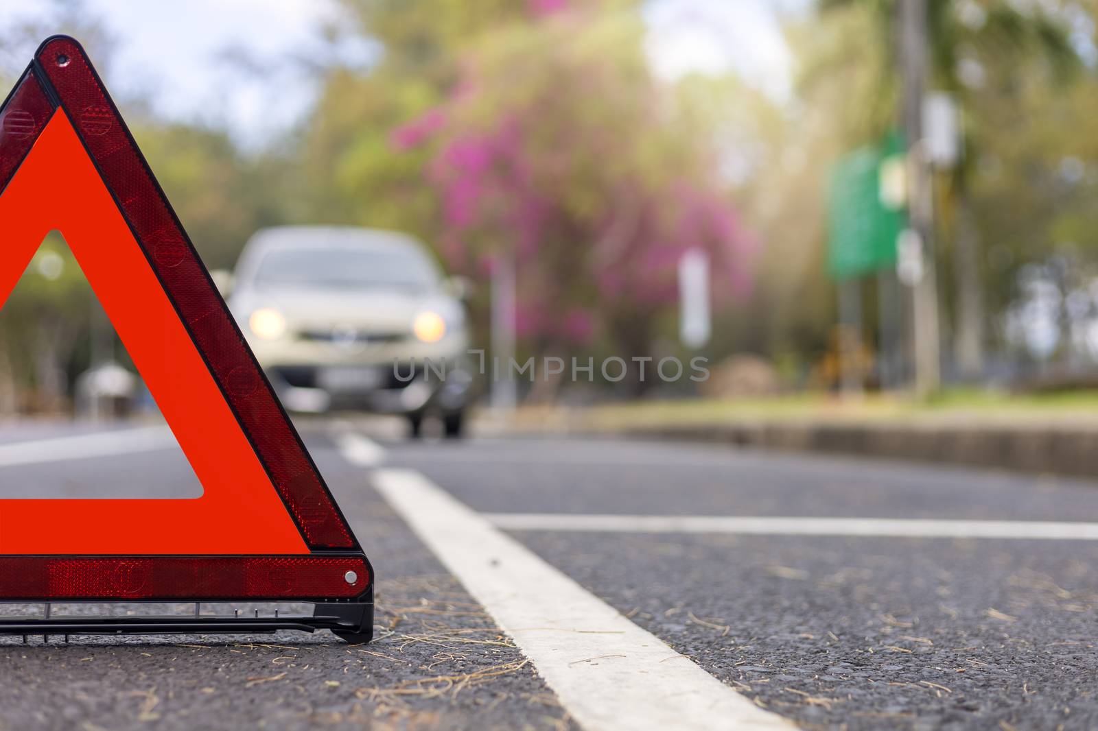 Red triangle, red emergency stop sign, red emergency symbol and  car stop and park on road.