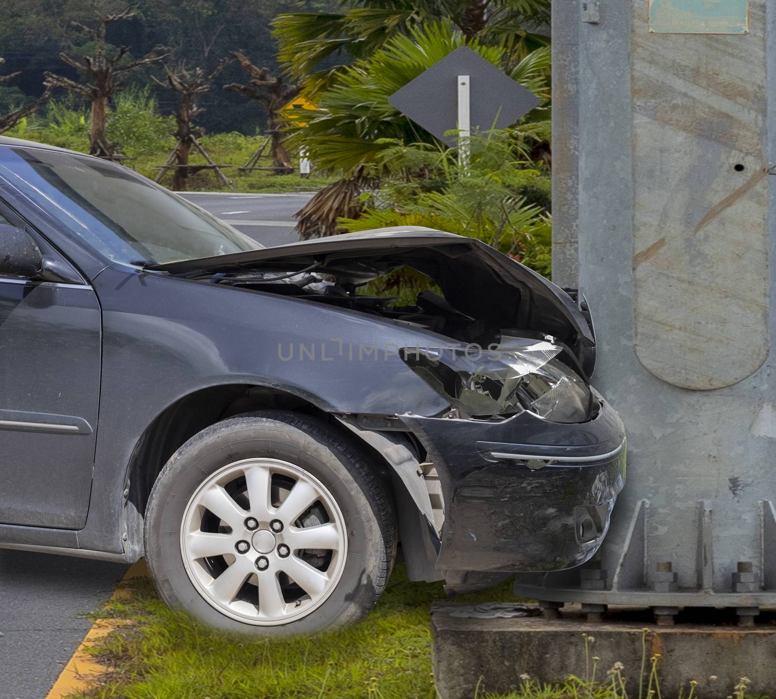 Car crash. Front of car crash with electric pole  have damaged and broken by accident on traffic road .