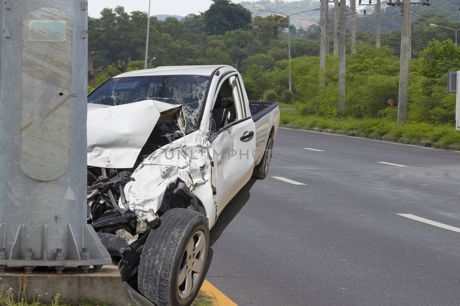 Car crash. Front of car crash with electric pole  have damaged and broken by accident on traffic road .