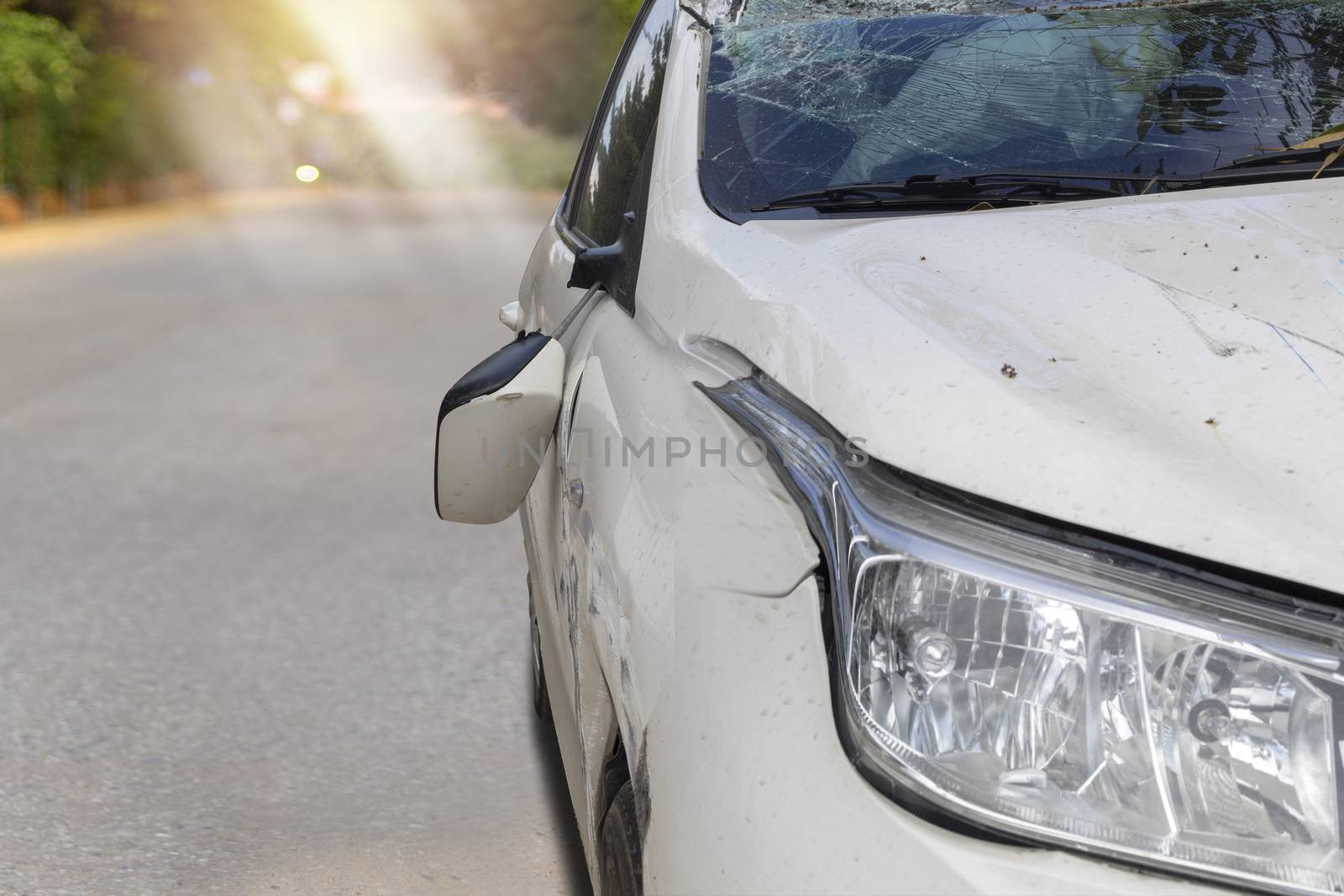 Front of white color car big damaged and broken by accident on road parking can not drive any more. With copy space for text or design