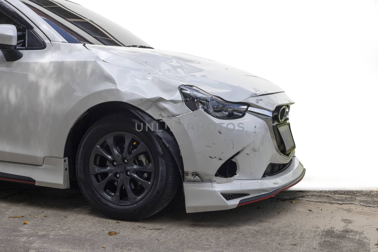 Front of white color car damaged and broken by accident isolated on white background. 