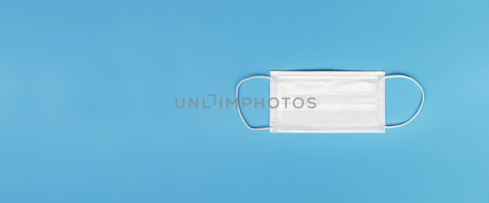 Medical mask isolated on blue background , Medical face mask isolated with copy space