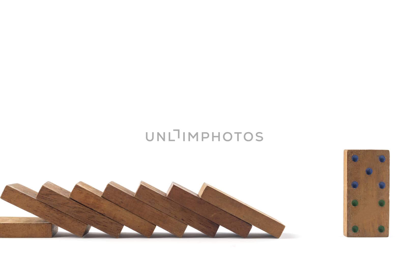 Social distancing concept wood domino toys on white background, . Domino effect. 8 dominos is falling and next one domino can stand.