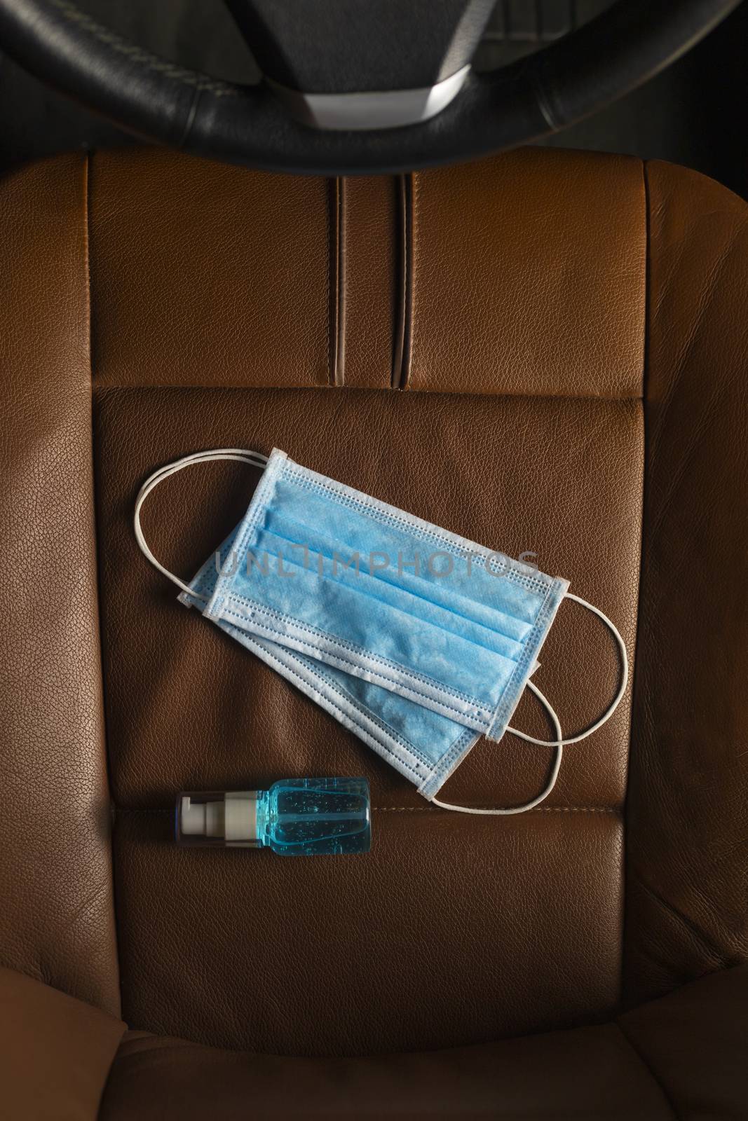 Top view Medical mask Alcohol Hand sanitizer gel on The car seat .