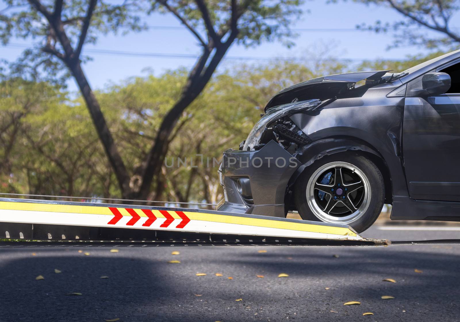 accident Car Slide on  truck for move. Gray car have damage by accident on road take with slide truck move . 