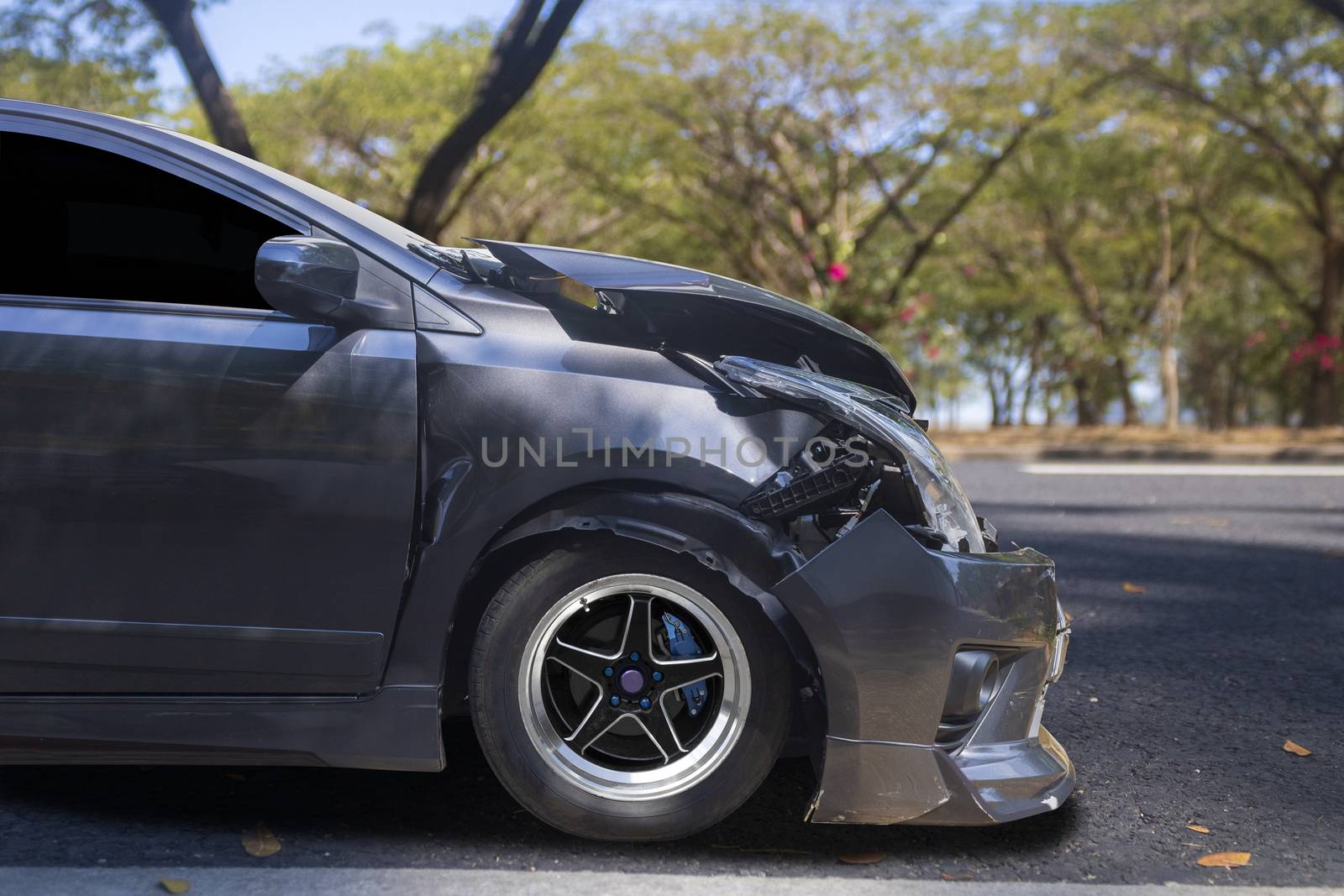 Front of gray color car big damaged and broken by accident on city street parking can not drive any more. With copy space for text or design