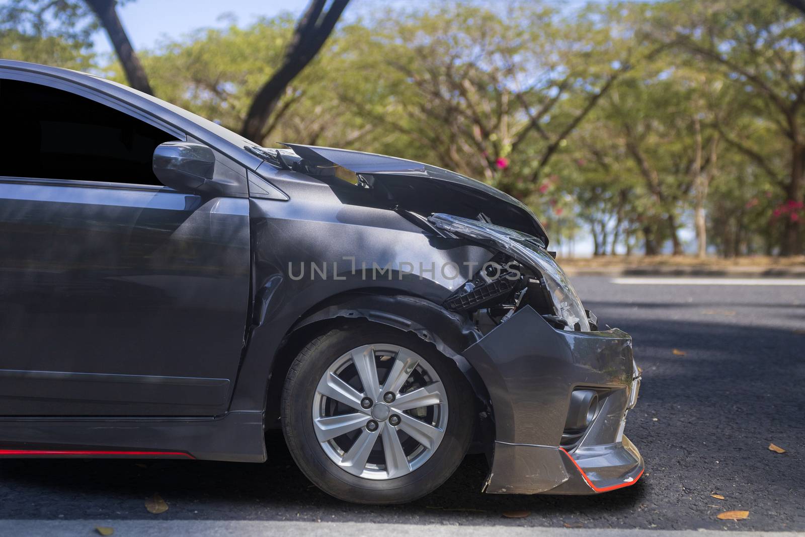 Front of gray color car big damaged and broken by accident on city street parking can not drive any more. With copy space for text or design