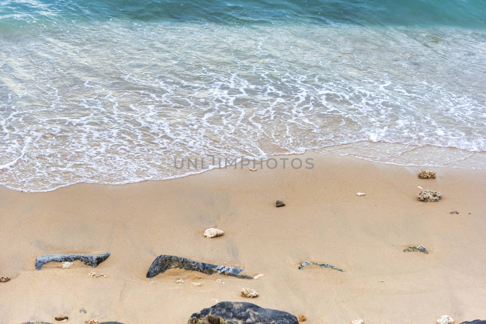 Top view Soft wave from sea come to wet sand beach background. With copy space for text or design