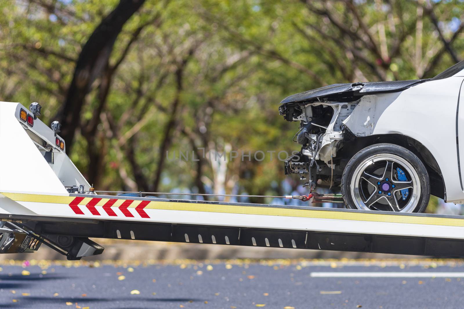 accident Car Slide on  truck for move. Gray car have damage by accident on road take with slide truck move . 