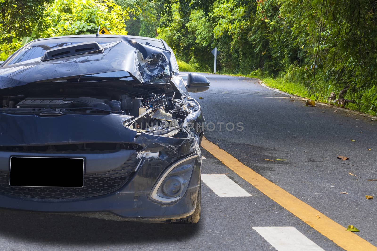 Front of blue color car with pick up have big damaged and broken by accident on road in morning time can not drive any more park for wait insurance officer. With copy space for text or design