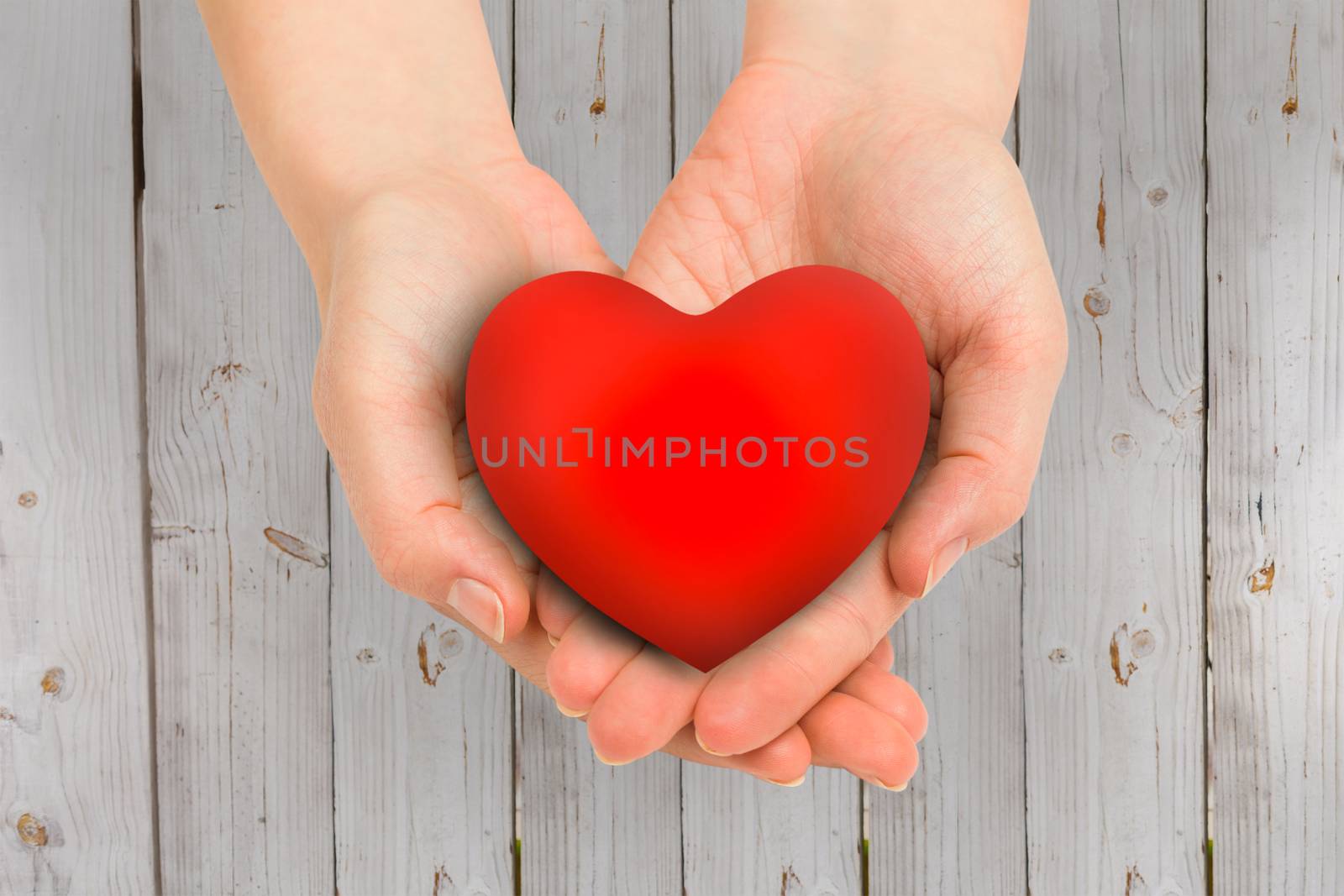 Composite image of hand showing heart by Wavebreakmedia