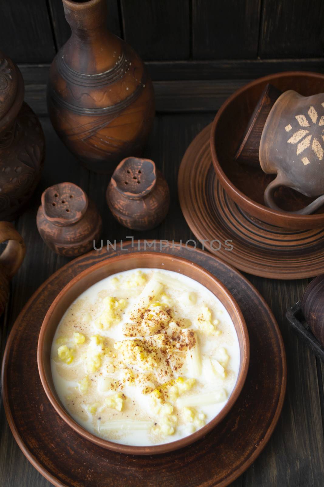Milk traditional soup of Belarus with noodles and dough in a ceramic bowl on dark rustic table