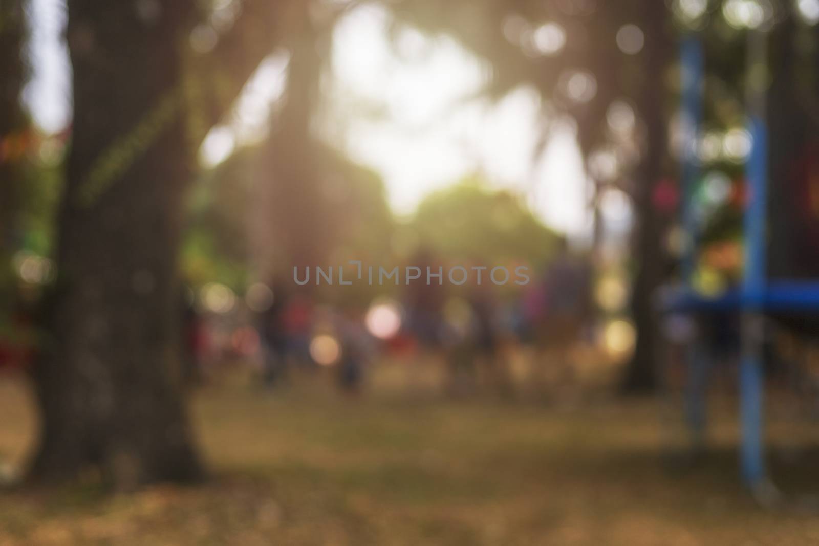 Blur image people walking in the park and playground with bokeh  by Satrinekarn