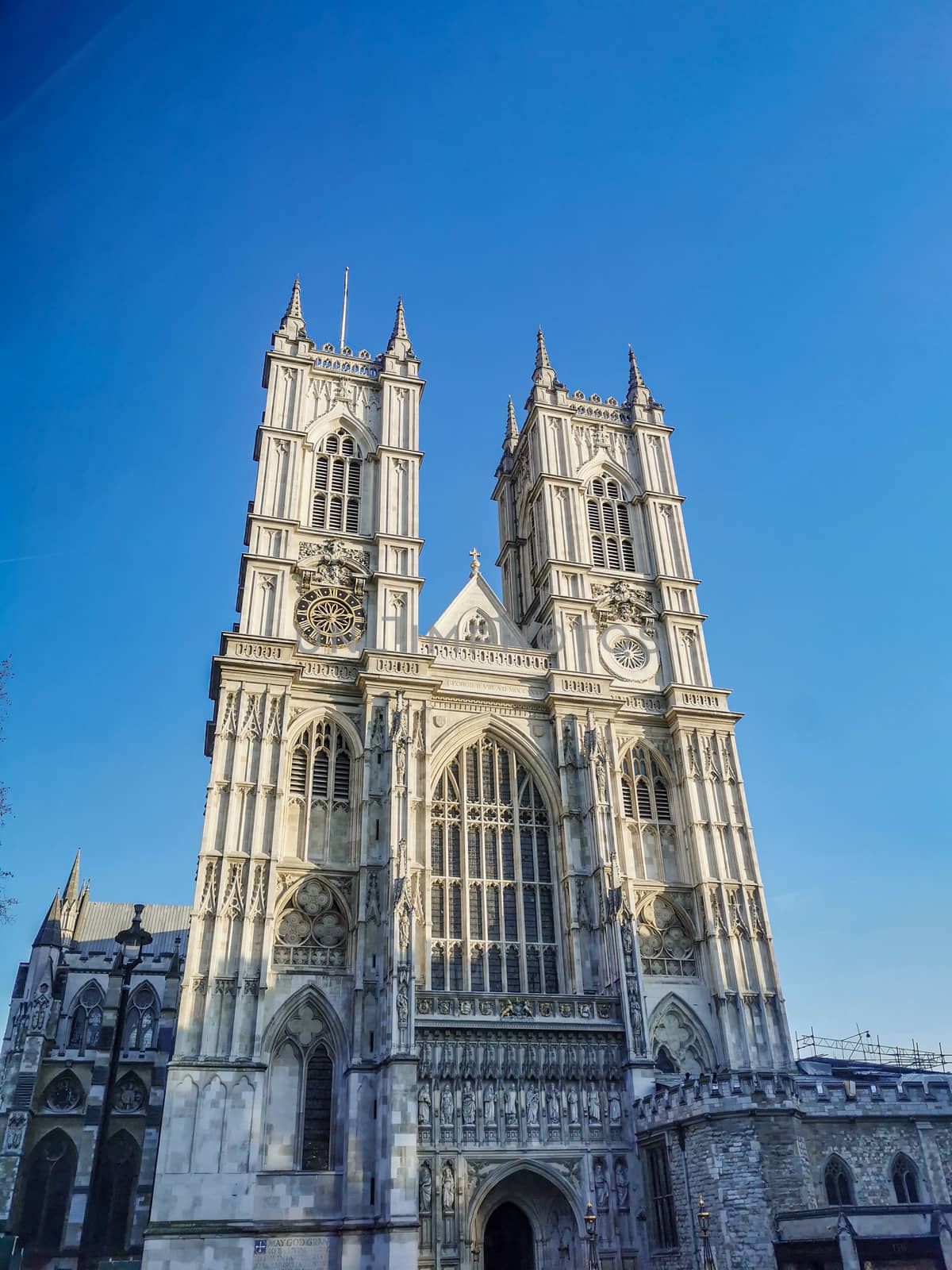 Westminster Abbey Church against bright blue sky during sunset.  by sonandonures