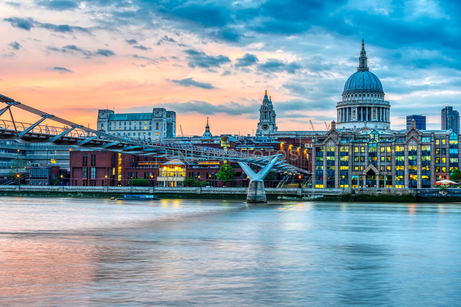 St. Paul's Cathedral and the Millennium Bridge in London, UK, after sunset