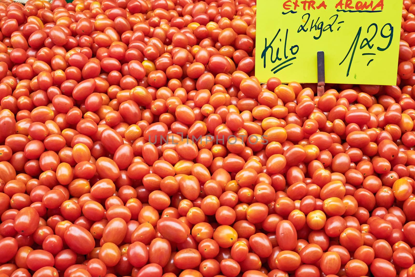 Pile of small tomatoes for sale at a market