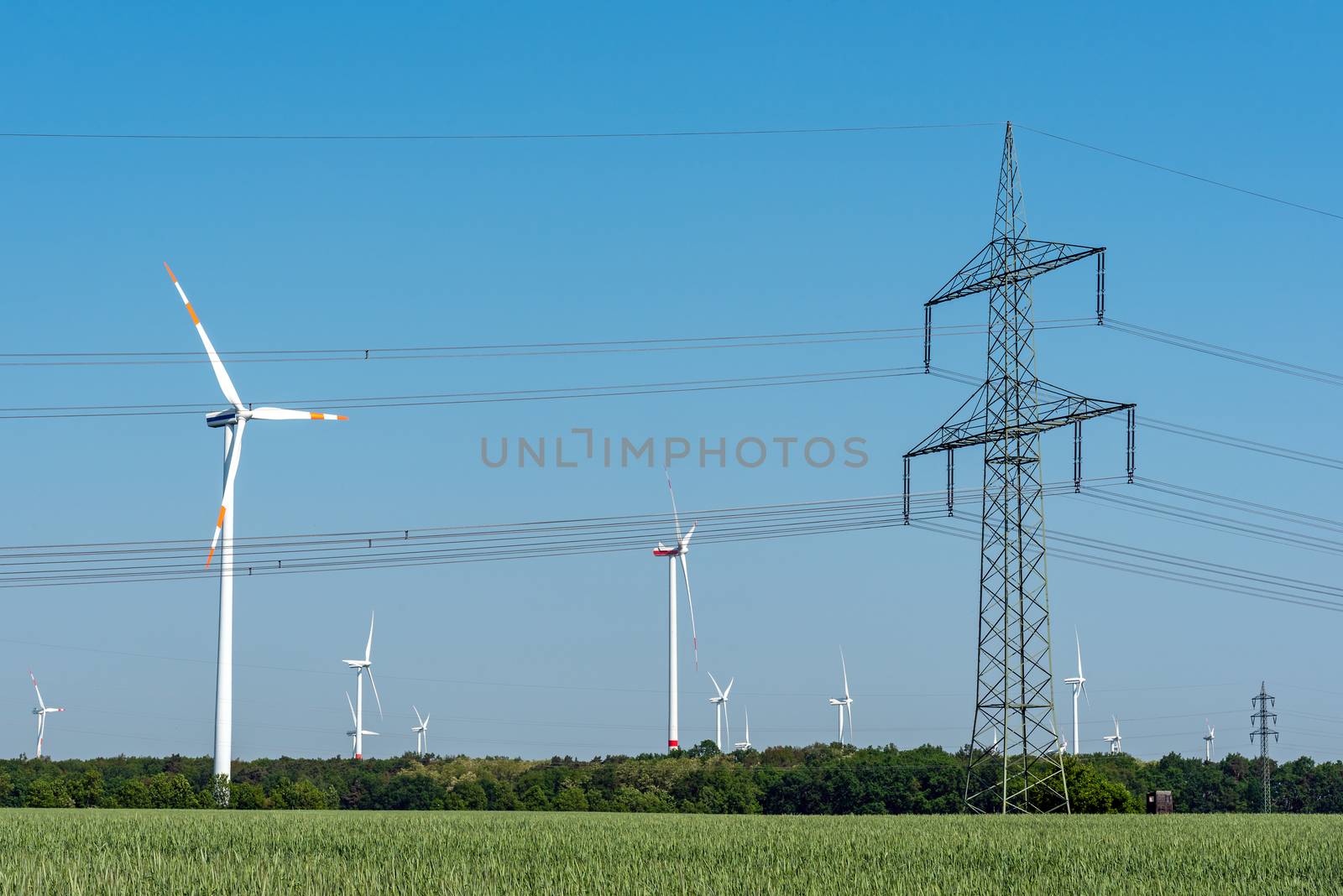 Overhead power line and wind turbines seen in rural Germany
