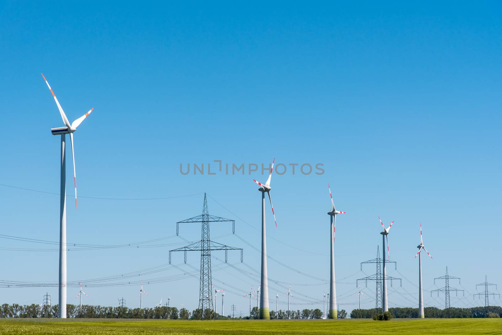 Wind energy plants and an overhead power line seen in Germany