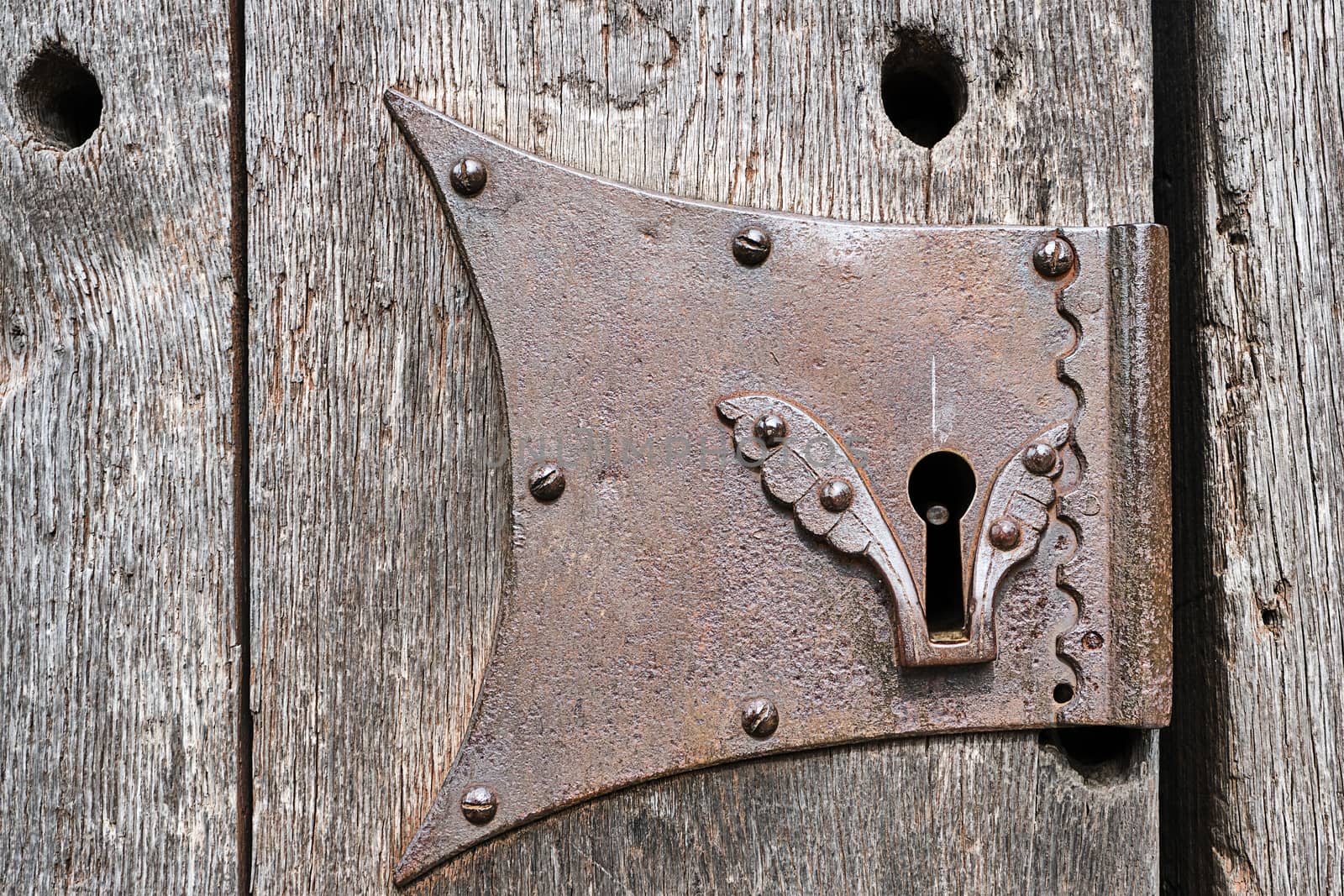 Detail of a keyhole of an old wooden door