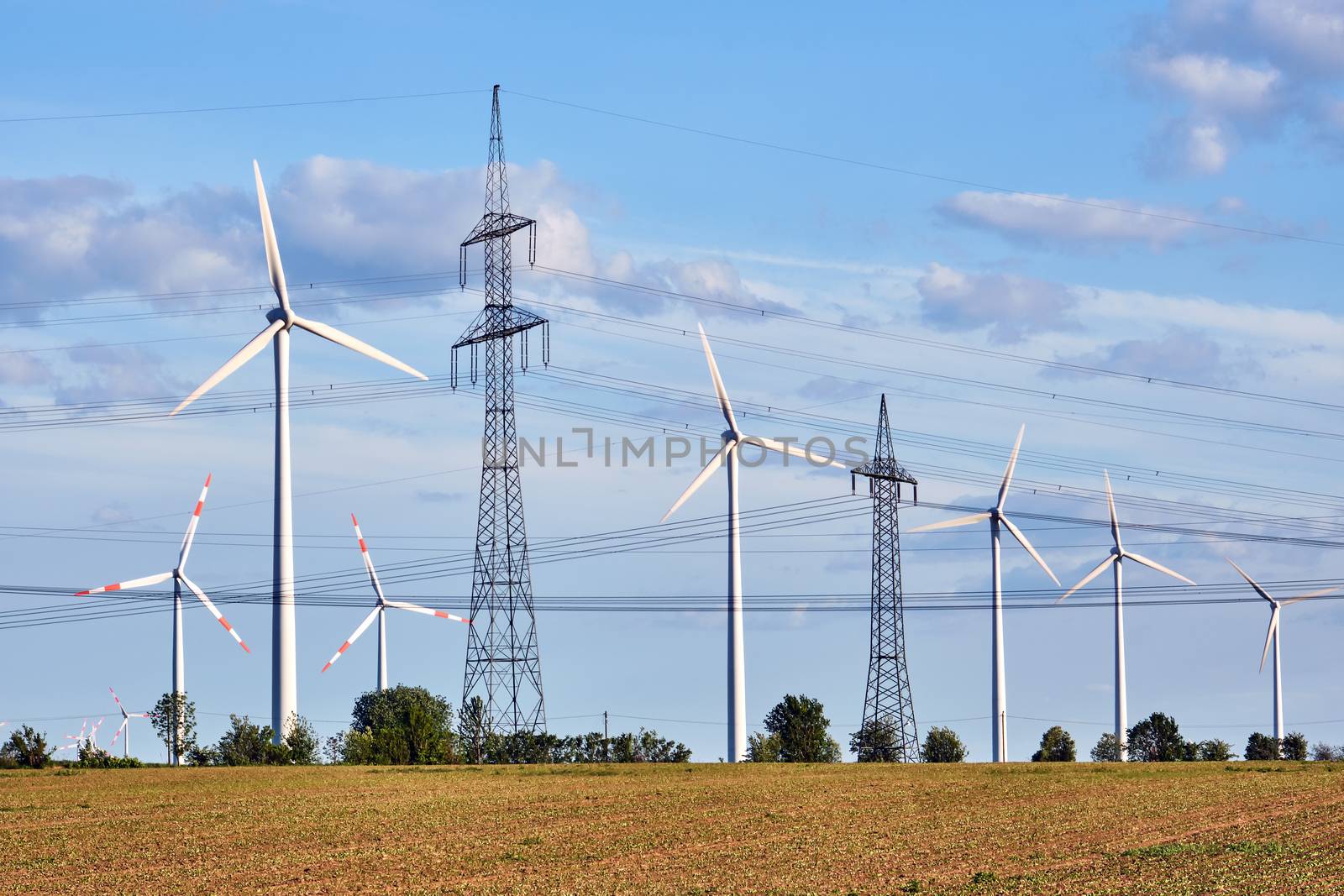 Wind turbines and power lines behind an acre seen in Germany