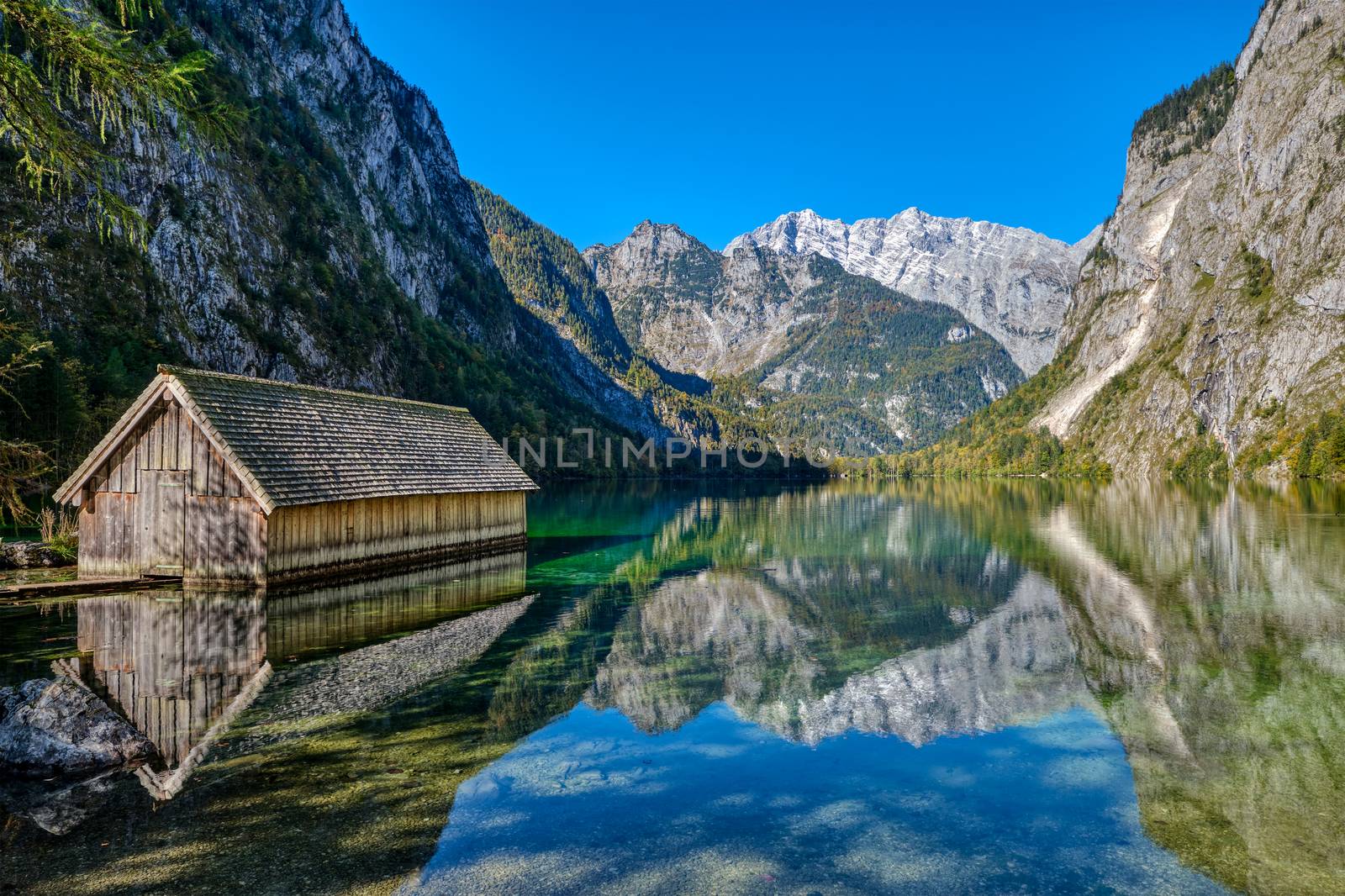 The beautiful Obersee in the Bavarian Alps with a wooden boathouse