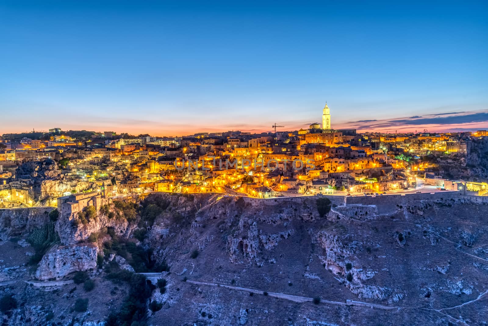 View of the beautiful old town of Matera and the canyon of the Gravina by elxeneize