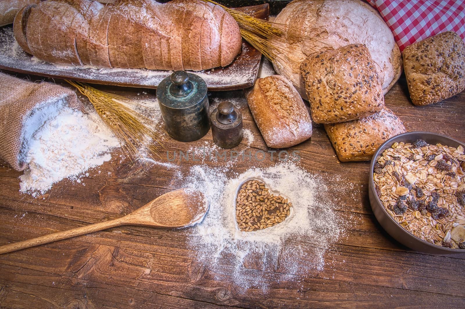 Bread and flour on a rustic wooden table. Bakery and grocery food store concept.