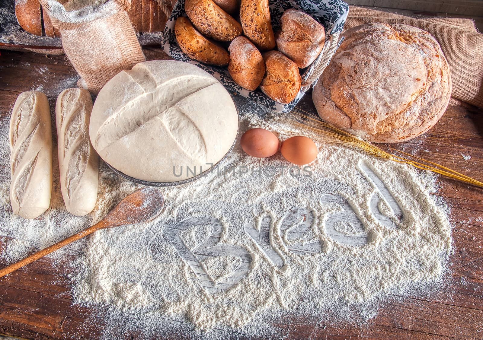 Bread and flour on a rustic wooden table. Bakery and grocery food store concept.