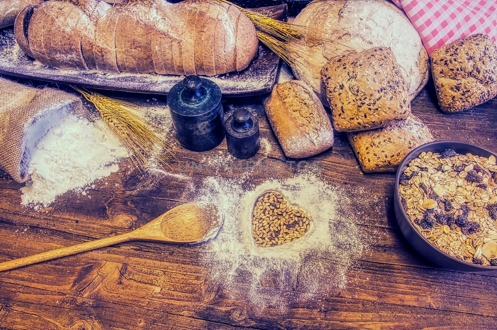 Bread and flour on a rustic wooden table. by CreativePhotoSpain