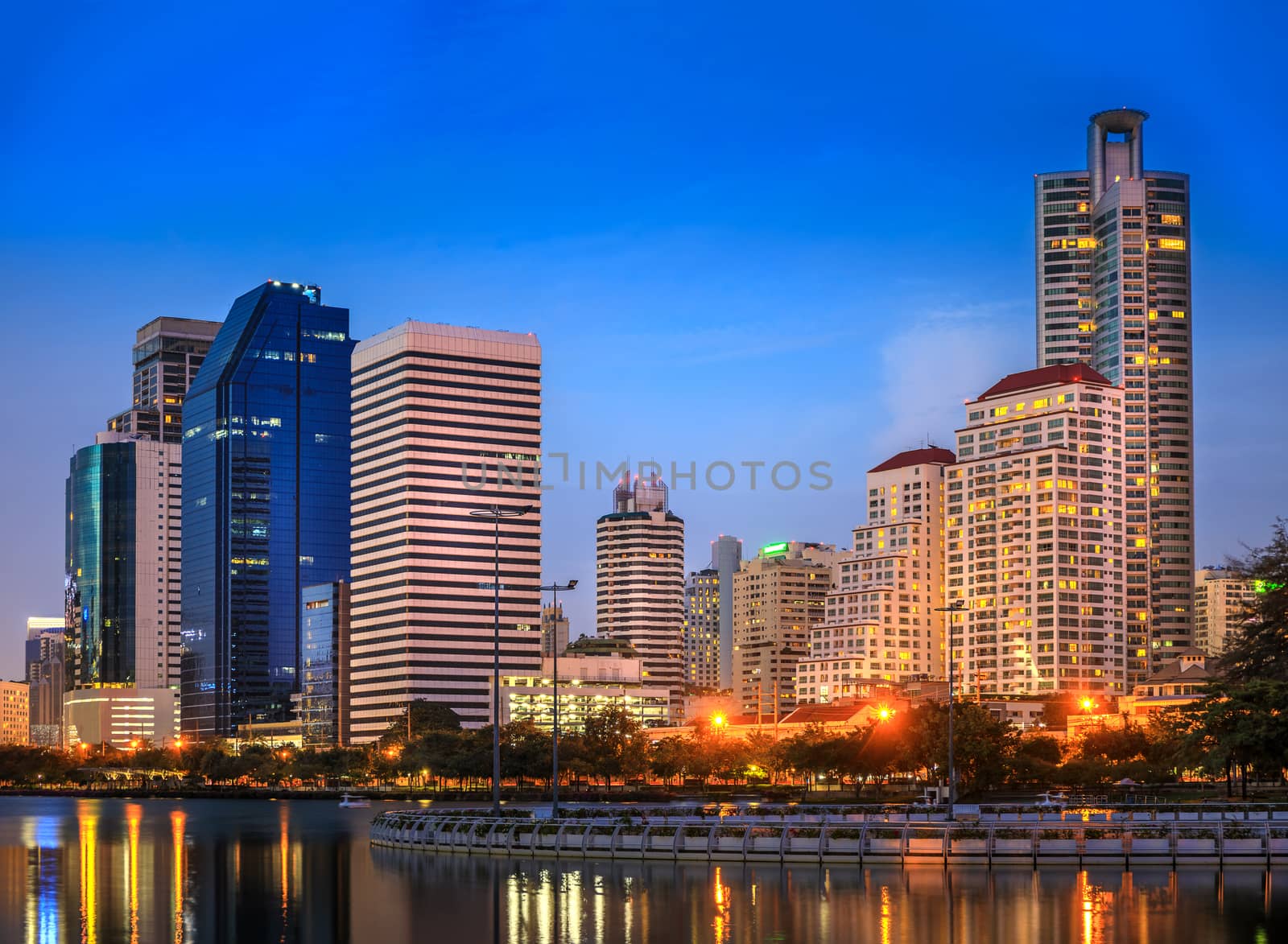 Modern buildings in office district at night in Bangkok, Thailand.