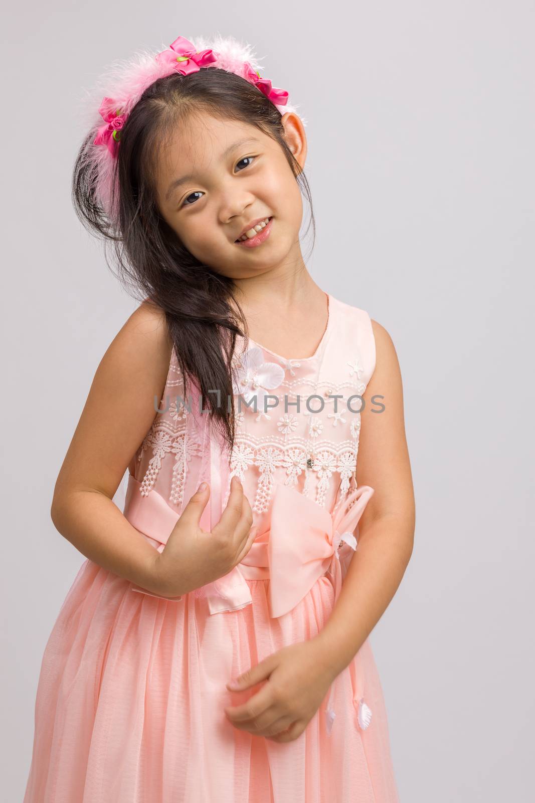 Child in peach princess dress, isolated on white background.