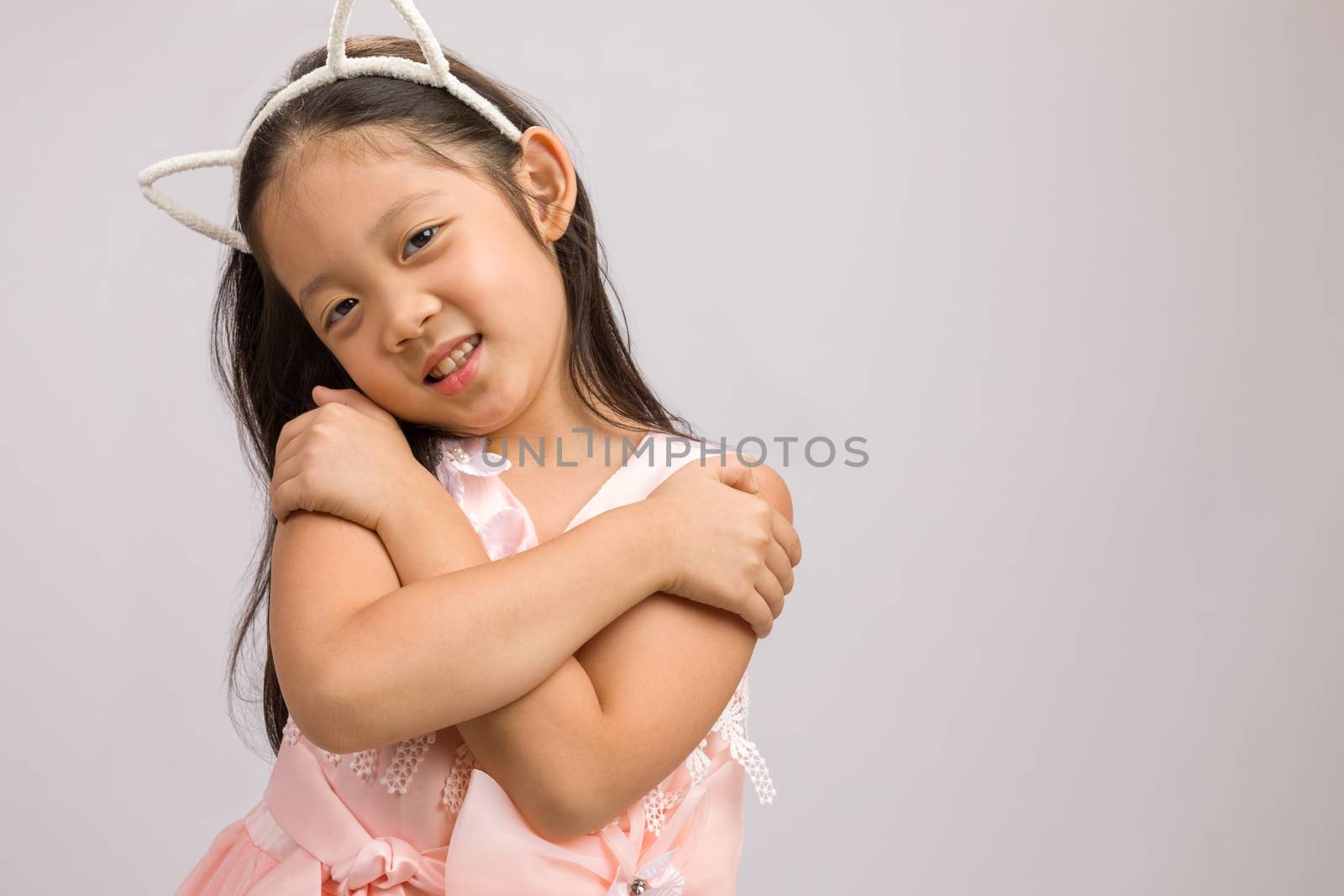 Kid with cat ear headband, isolated on white background.