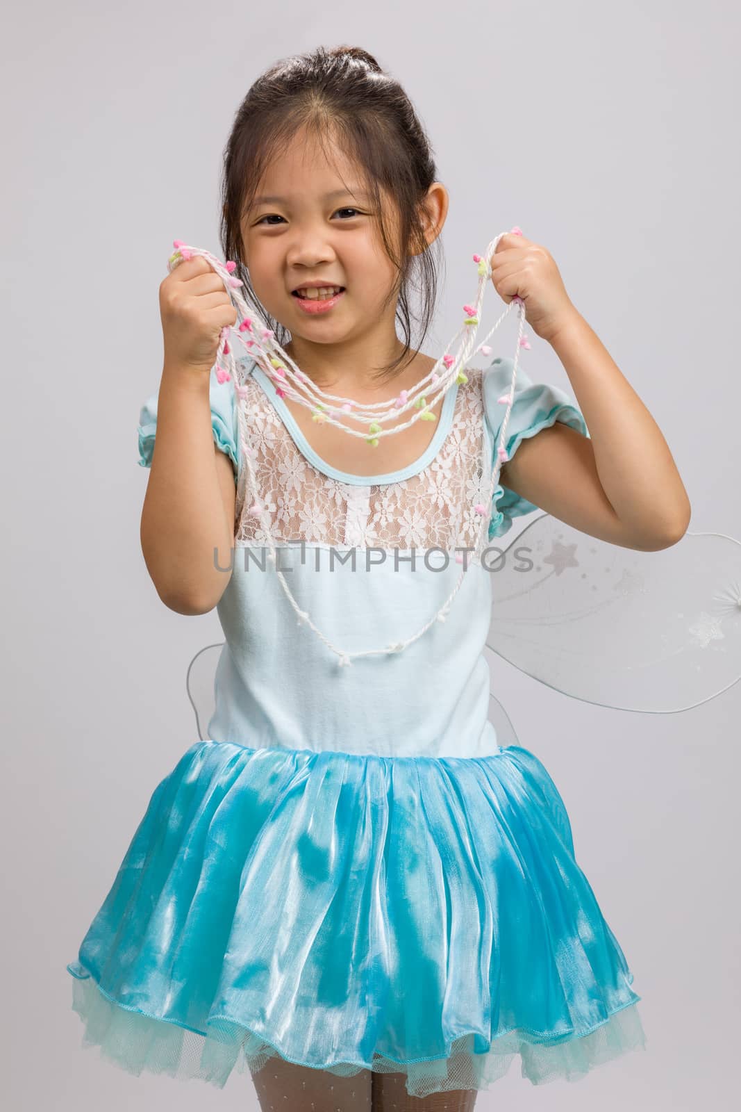 Child in ballet dress, isolated on white background.