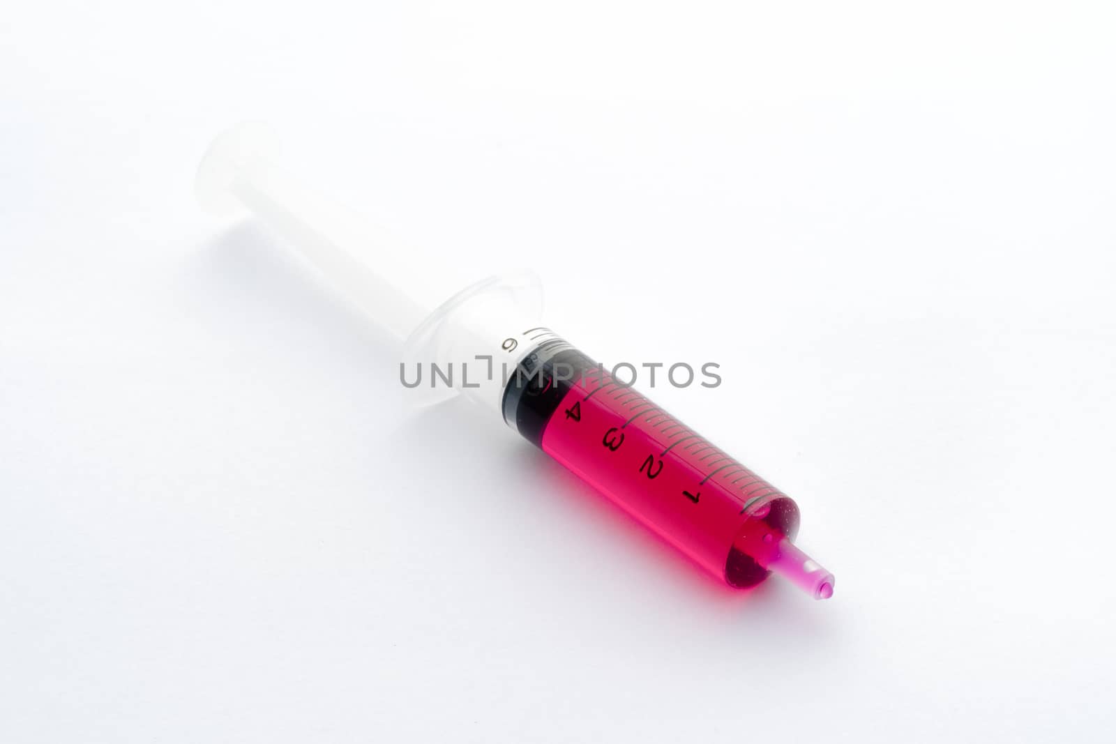 Studio shot of syringe containing liquid medicine for kid isolated on white background.