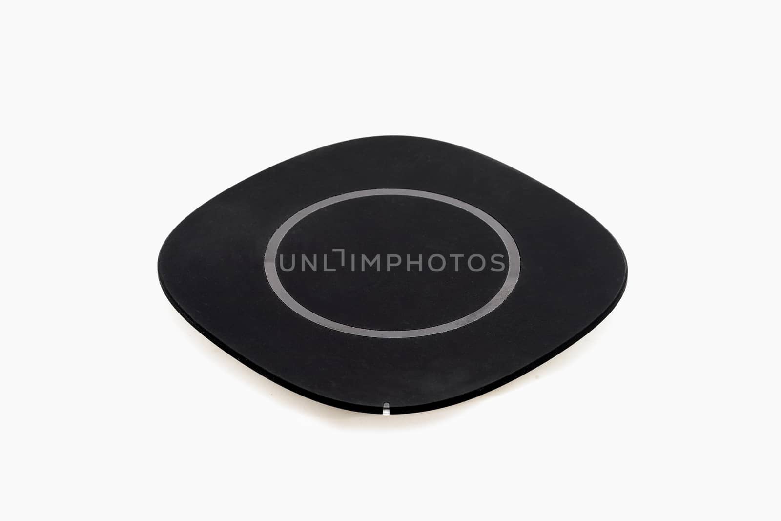Isolated wireless charger for smartphone on white background.
