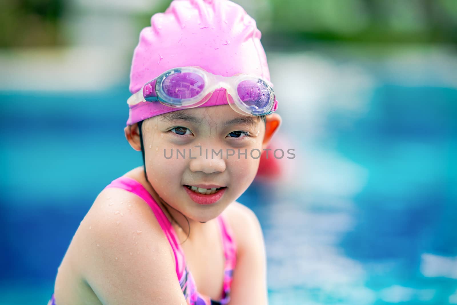Little girl, child, having fun at swimming pool.